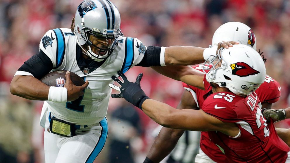 Carolina Panthers quarterback Cam Newton (1) gives Arizona Cardinals inside linebacker Zaven Collins (25) a shove as Newton runs for a touchdown during the first half of an NFL football game Sunday, Nov. 14, 2021, in Glendale, Ariz. (AP Photo/Ralph Freso)