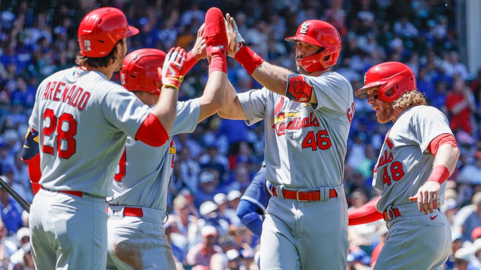 St. Louis Cardinals' Paul Goldschmidt (46) celebrates with teammates after hitting a three-run home run against the Chicago Cubs during the third inning of a baseball game, Friday, June 3, 2022, in Chicago. (AP Photo/Kamil Krzaczynski)