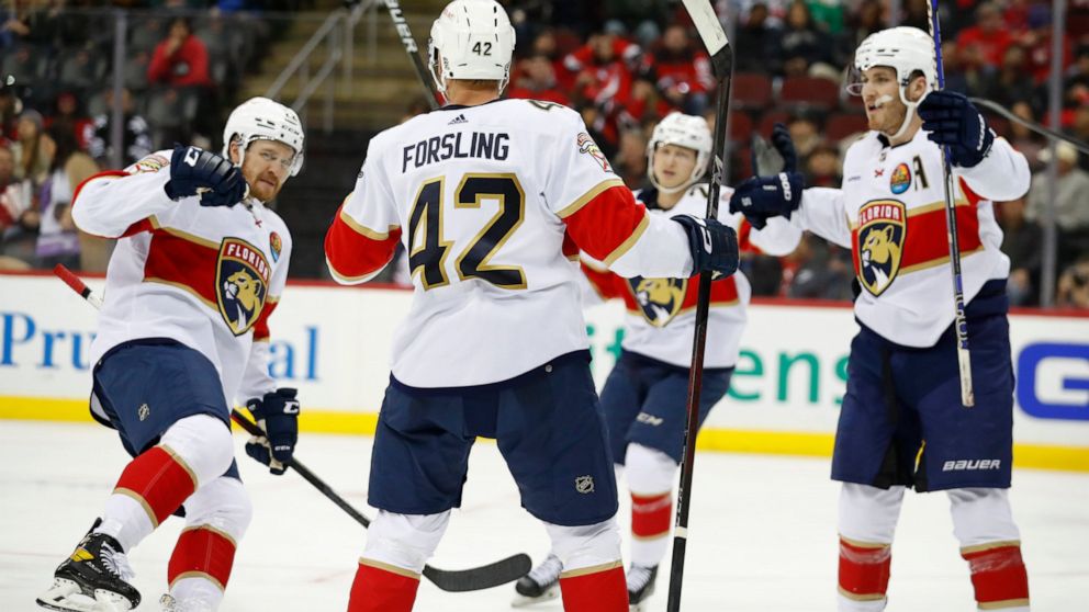 Florida Panthers defenseman Gustav Forsling (42) celebrates with teammates after scoring a goal against the New Jersey Devils during the second period of an NHL hockey game, Saturday Dec. 17, 2022, in Newark, N.J. (AP Photo/Noah K. Murray)