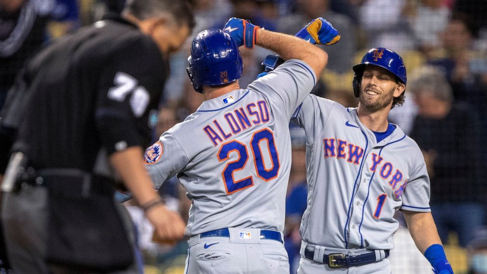 New York Mets' Jeff McNeil, right, congratulates Pete Alonso, who hit a two-run home run against the Los Angeles Dodgers during the third inning of a baseball game in Los Angeles, Saturday, June 4, 2022. (AP Photo/Alex Gallardo)