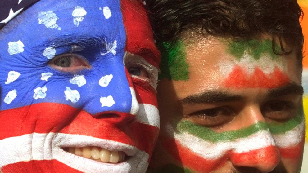 FILE - Mike Moscrop, left, from Orange County, Calif., poses with Amir Sieidoust, an Iranian supporter living in Holland outside the Gerlain Stadium in Lyon, June 21, 1998, before the start of the USA vs Iran World Cup soccer match. Iran defeated the
