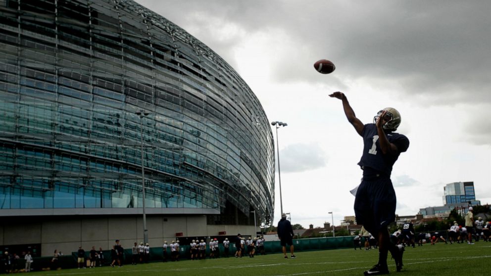 FILE - Navy quarterback Trey Miller during a training session at the Aviva Stadium, Dublin, Ireland, Aug. 30, 2012. College football is going international again with Nebraska facing Northwestern in Dublin on Saturday Aug. 27, 2022. It's the first re