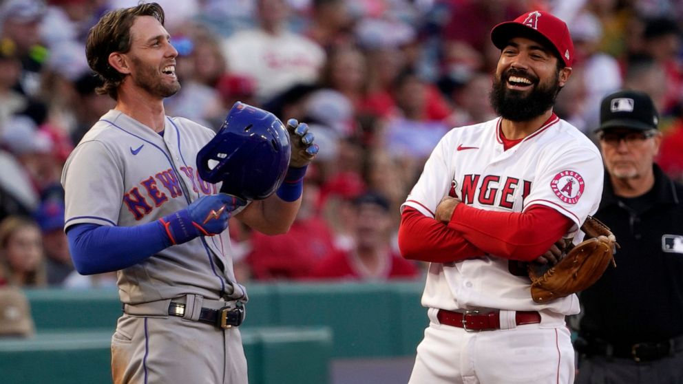 New York Mets' Jeff McNeil, left, chats with Los Angeles Angels third baseman Anthony Rendon during the first inning of a baseball game Friday, June 10, 2022, in Anaheim, Calif. (AP Photo/Mark J. Terrill)