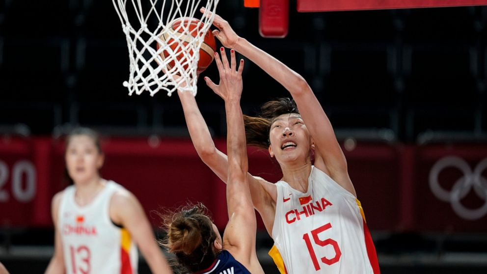 FILE - China's Han Xu (15) shoots over Serbia's Tina Krajisnik during a women's basketball quarterfinal at the 2020 Summer Olympics, Aug. 4, 2021, in Saitama, Japan. After missing the last two seasons while she stayed at home in China, dealing with t