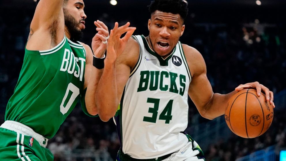 Milwaukee Bucks' Giannis Antetokounmpo gets past Boston Celtics' Jayson Tatum during the first half of Game 3 of an NBA basketball Eastern Conference semifinals playoff series Saturday, May 7, 2022, in Milwaukee. (AP Photo/Morry Gash)