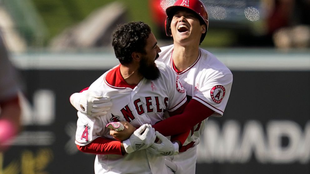 Los Angeles Angels designated hitter Shohei Ohtani (17) celebrates with Anthony Rendon (6) after a 5-4 win over the Washington Nationals in a baseball game in Anaheim, Calif., Sunday, May 8, 2022. Rendon hit a walk-off single, allowing Ohtani to scor