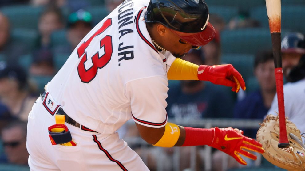 Atlanta Braves Ronald Acuna Jr. reacts after being hit with a pitch in the third inning of a baseball game against the Miami Marlins on Saturday, May 28, 2022, in Atlanta. (AP Photo/Bob Andres)