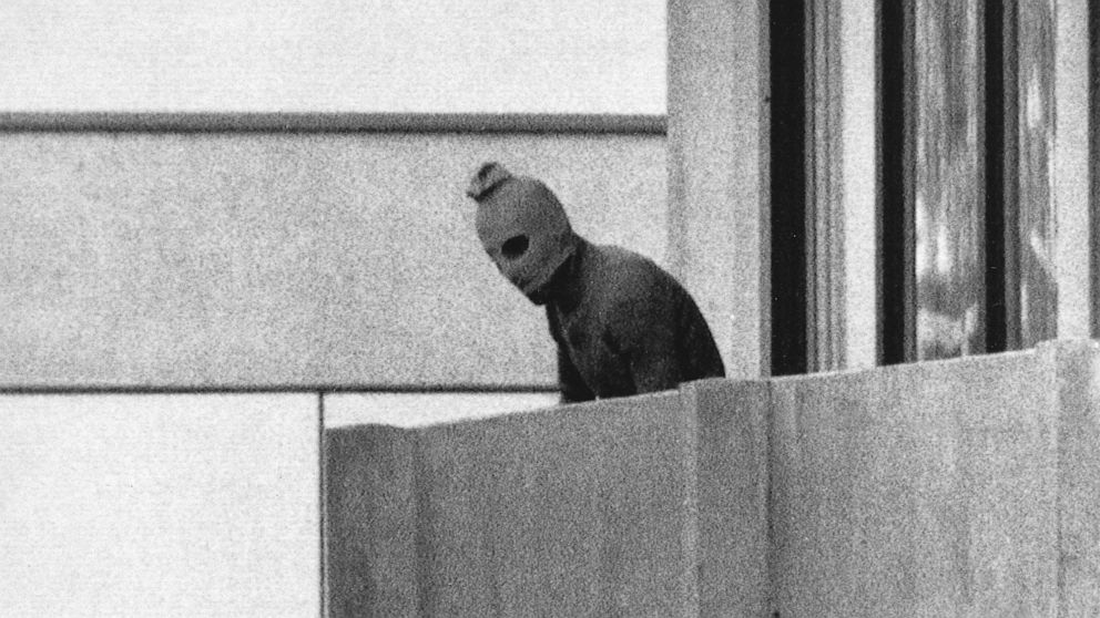 FILE - File Photo from Sept. 5, 1972 shows a member of the Arab Commando group which seized members of the Israeli Olympic Team at their quarters at the Munich Olympic Village appearing with a hood over his face on the balcony of the village building