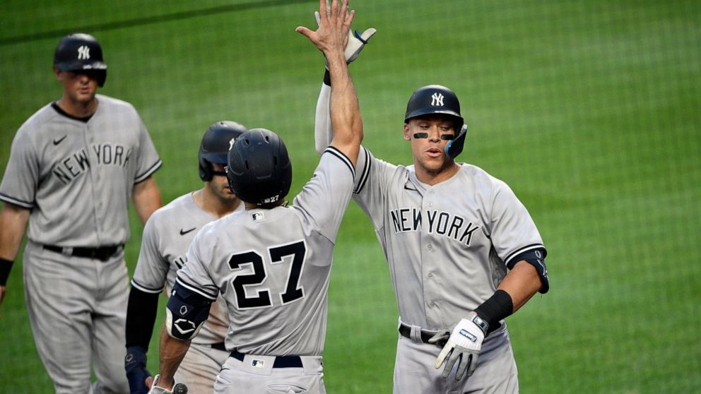 New York Yankees' Aaron Judge, right, celebrates his three-run home run with Giancarlo Stanton (27) during the third inning of a baseball game against the Baltimore Orioles, Friday, July 22, 2022, in Baltimore. (AP Photo/Nick Wass)