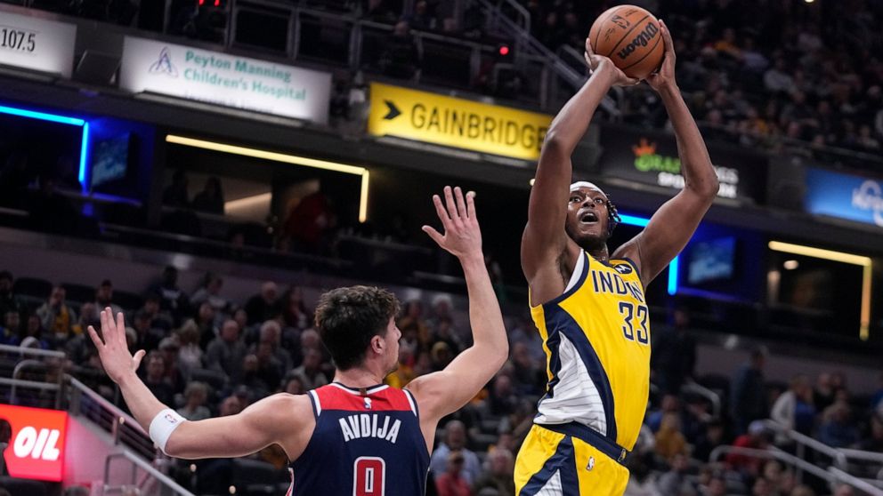 Indiana Pacers center Myles Turner (33) shoots over Washington Wizards forward Deni Avdija (9) during the first half of an NBA basketball game, Friday, Dec. 9, 2022, in Indianapolis. (AP Photo/Darron Cummings)