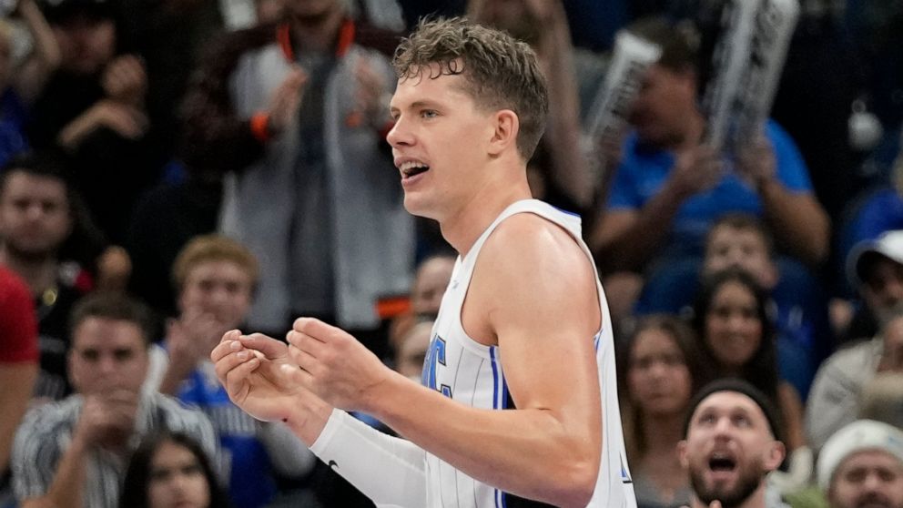 Orlando Magic's Moritz Wagner reacts after drawing a charging foul from Toronto Raptors' Gary Trent Jr. during the second half of an NBA basketball game Friday, Dec. 9, 2022, in Orlando, Fla. (AP Photo/John Raoux)