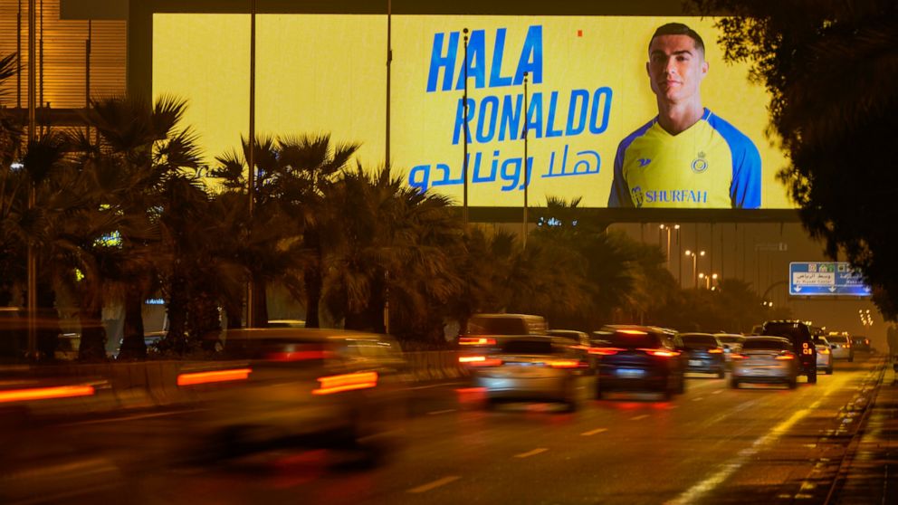 Vehicles pass under a billboard showing Cristiano Ronaldo with Arabic reading, "Welcome Ronaldo", in Riyadh, Saudi Arabia, late Monday, Jan 2, 2023. Ronaldo completed a lucrative move to Saudi Arabian club Al Nassr on Friday in a deal that is a landm