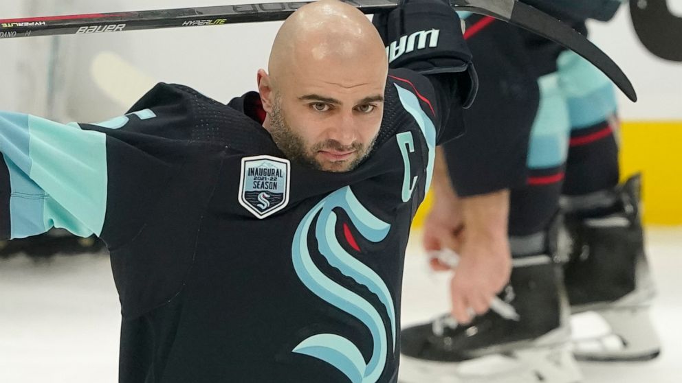 Seattle Kraken defenseman Mark Giordano holds his stick during warmups before an NHL hockey game against the Tampa Bay Lightning, Wednesday, March 16, 2022, in Seattle. Giordano was honored before the game for his 1000th career NHL game, which took p