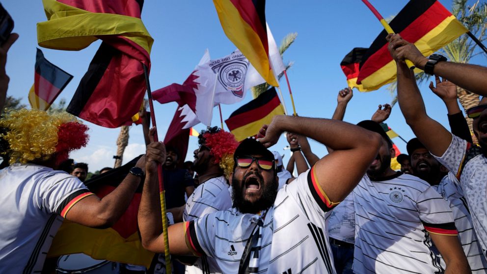 German fans cheer at flag plaza in Doha, Qatar, Friday, Nov. 11, 2022. Final preparations are being made for the soccer World Cup which starts on Nov. 20 when Qatar face Ecuador. (AP Photo/Hassan Ammar)