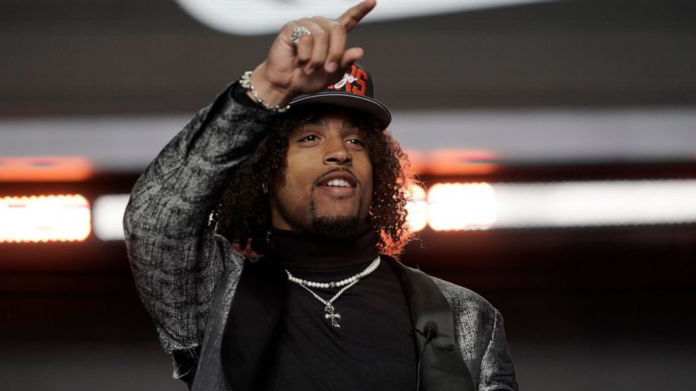Washington cornerback Kyler Gordon points after being selected by the Chicago Bears during the second round of the NFL football draft Friday, April 29, 2022, in Las Vegas. (AP Photo/Jae C. Hong)