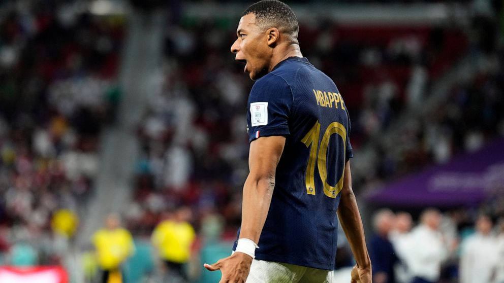 France's Kylian Mbappe celebrates scoring his side's third goal during the World Cup round of 16 soccer match between France and Poland, at the Al Thumama Stadium in Doha, Qatar, Sunday, Dec. 4, 2022. (AP Photo/Martin Meissner)