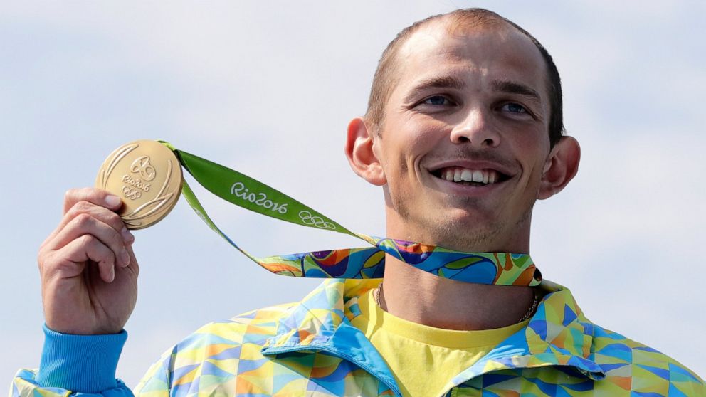 FILE - Ukraine's Yuri Cheban celebrates his gold medal in the men's canoe single 200m final during the 2016 Summer Olympics in Rio de Janeiro on Aug. 18, 2016. Cheban, one of Ukraine's most decorated Olympians, told The Associated Press in an email e