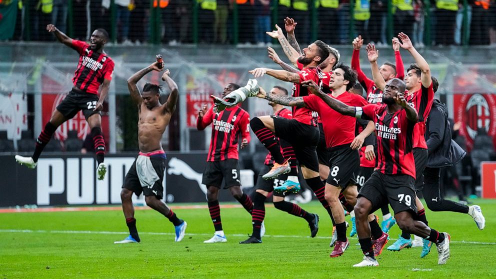 AC Milan players celebrate at the end of the Serie A soccer match between AC Milan and Genoa, at the San Siro stadium in Milan, Italy, Friday, April 15, 2022. AC Milan won 2-0. (AP Photo/Luca Bruno)
