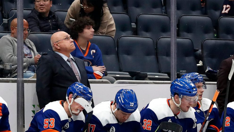 New York Islanders head coach Barry Trotz looks at the score board after the Carolina Hurricanes scored two empty net goals during the third period of an NHL hockey game, Sunday, Apr. 24, 2022, in New York. (AP Photo/Noah K. Murray)