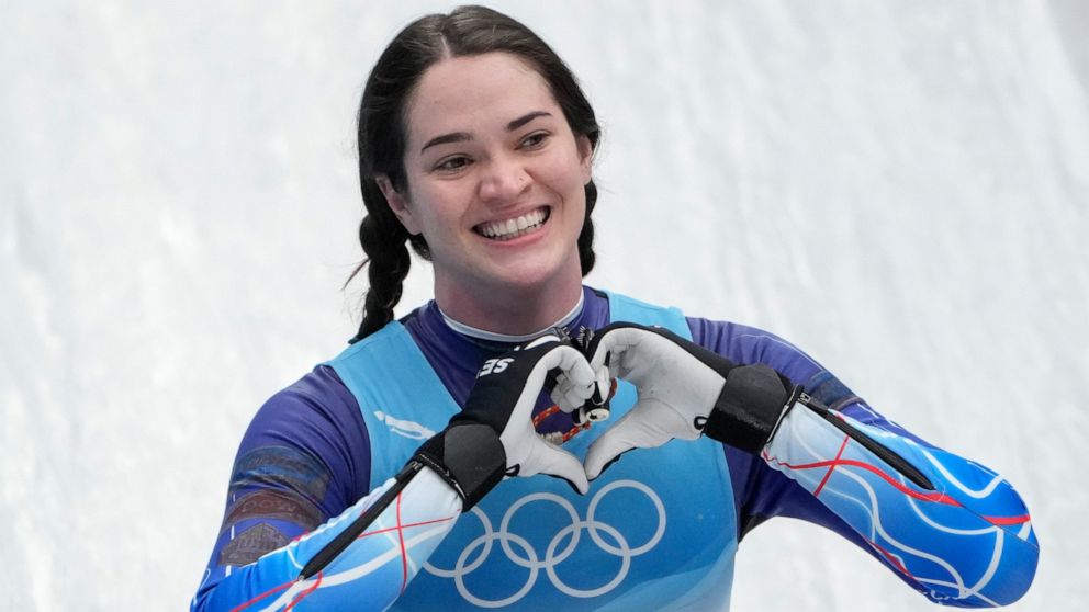 FILE - Summer Britcher, of the United States, finishes the luge women's singles run 3 at the 2022 Winter Olympics, Tuesday, Feb. 8, 2022, in the Yanqing district of Beijing. Summer Britcher and Emily Sweeney have been USA Luge teammates for years. Th