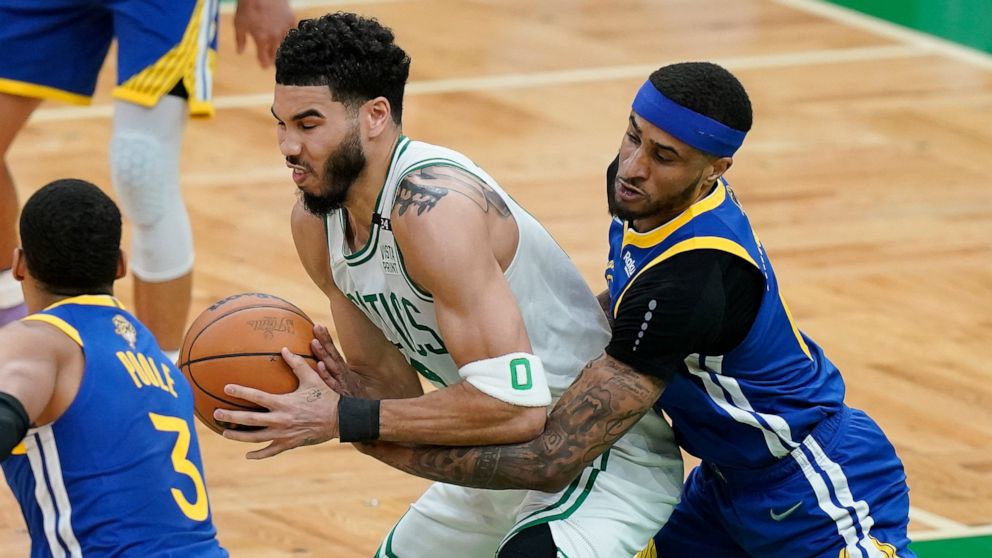 Golden State Warriors guard Gary Payton II (0) tries to strip the ball from Boston Celtics forward Jayson Tatum (0) during the first quarter of Game 6 of basketball's NBA Finals, Thursday, June 16, 2022, in Boston. (AP Photo/Steven Senne)