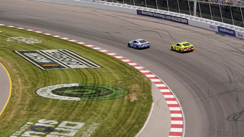 Chase Briscoe (14) and Austin Cindric (2) enter Turn 2 during a NASCAR Cup Series auto race at World Wide Technology Raceway, Sunday, June 5, 2022, in Madison, Ill. (AP Photo/Jeff Roberson)