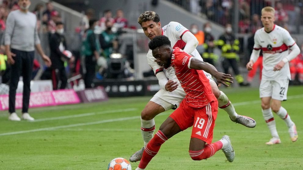 Bayern's Alphonso Davies, front, duels for the ball with Stuttgart's Omar Marmoush during the German Bundesliga soccer match between Bayern Munich and Stuttgart, at the Allianz Arena, in Munich, Germany, Sunday, May 8, 2022. (AP Photo/Michael Probst )
