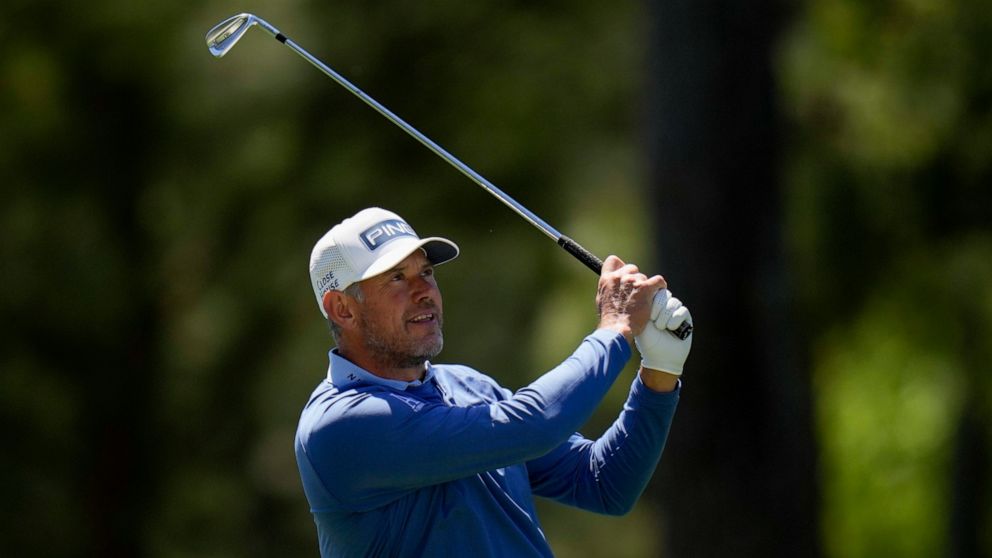 Lee Westwood, of England, watches his shot on the first fairway during the final round at the Masters golf tournament on Sunday, April 10, 2022, in Augusta, Ga. (AP Photo/Jae C. Hong)