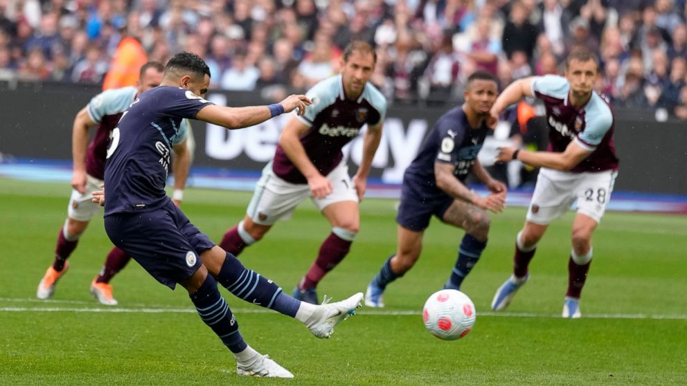 Manchester City's Riyad Mahrez takes a penalty during the English Premier League soccer match between West Ham United and Manchester City at London stadium in London, Sunday, May 15, 2022. (AP Photo/Kirsty Wigglesworth)
