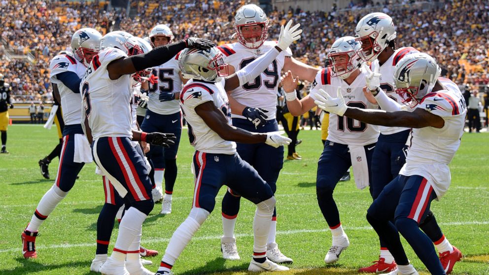 New England Patriots wide receiver Nelson Agholor, center, celebrates after taking a 44-yard pass play for a touchdown during the first half of an NFL football game against the Pittsburgh Steeler in Pittsburgh, Sunday, Sept. 18, 2022. (AP Photo/Don W