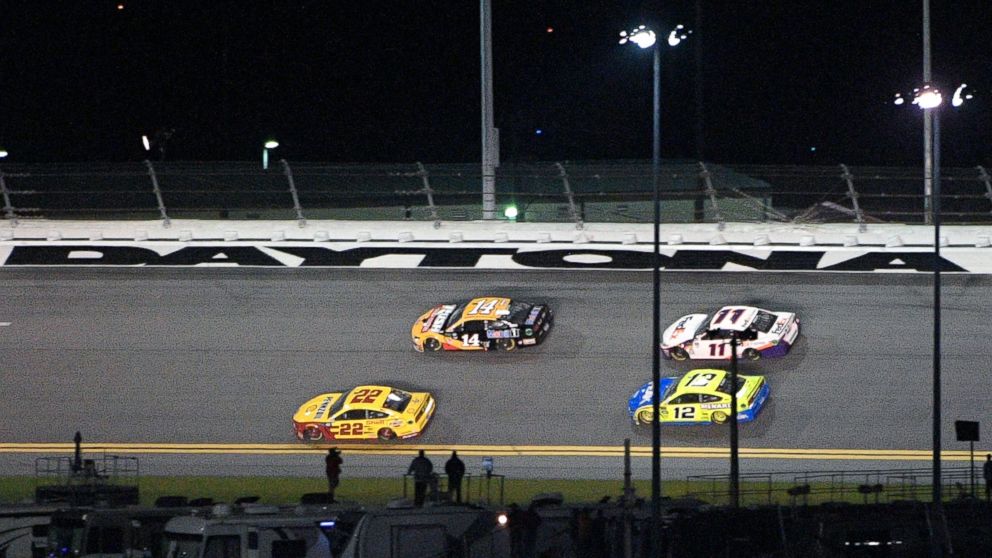 Joey Logano (22) passes Clint Bowyer (14) to take the lead on the final lap during the second of two qualifying races for the NASCAR Daytona 500 auto race at Daytona International Speedway, Thursday, Feb. 14, 2019, in Daytona Beach, Fla. (AP Photo/Ph
