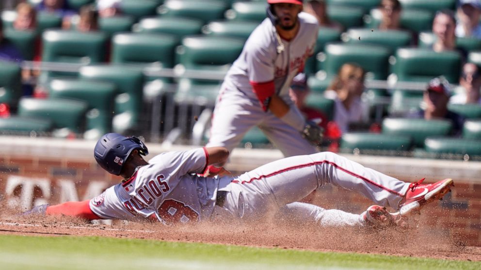 Washington Nationals' Josh Palacios (68) slides safely home in the fifth inning of a baseball game against the Atlanta Braves, Wednesday, Sept. 21, 2022, in Atlanta. (AP Photo/Brynn Anderson)
