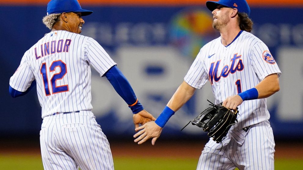New York Mets' Francisco Lindor (12) celebrates with Jeff McNeil (1) after the team's baseball game against the Cincinnati Reds on Tuesday, Aug. 9, 2022, in New York. The Mets won 6-2. (AP Photo/Frank Franklin II)