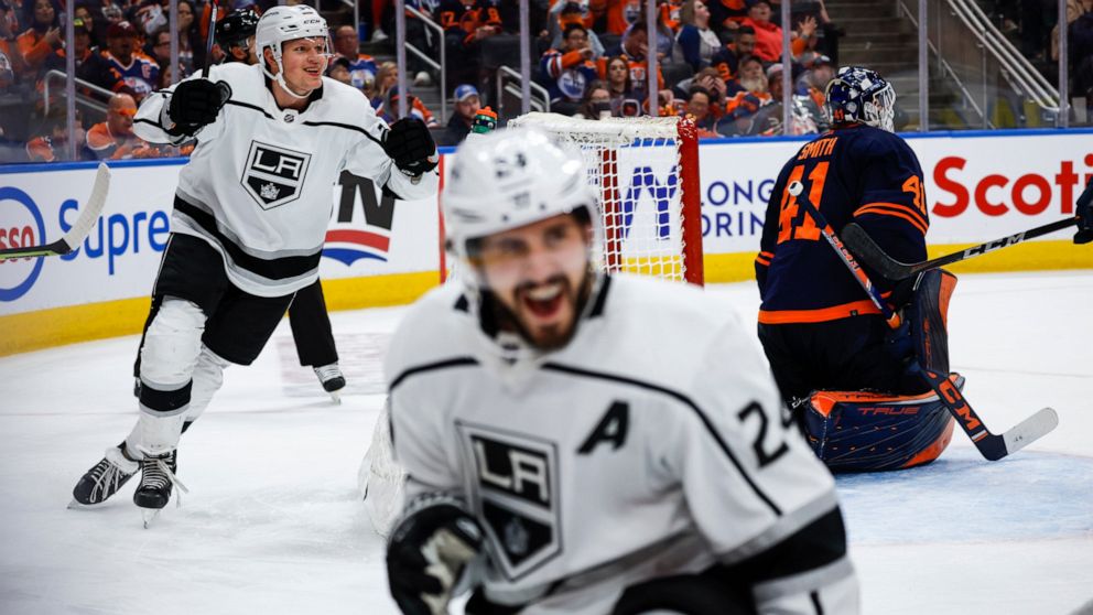 Los Angeles Kings center Phillip Danault, (24) celebrates his goal with teammate right wing Arthur Kaliyev, left, as Edmonton Oilers goalie Mike Smith looks away during the third period of Game 5 of an NHL hockey Stanley Cup first-round playoff serie