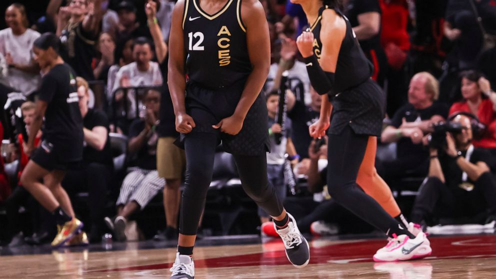 Las Vegas Aces guard Chelsea Gray (12) and forward A'ja Wilson celebrate after a play against the Minnesota Lynx during the second half of a WNBA basketball game Sunday, June 19, 2022, in Las Vegas. (Chase Stevens/Las Vegas Review-Journal via AP)