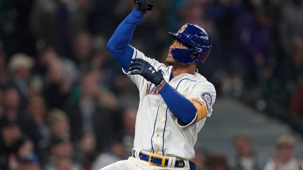 Seattle Mariners' Julio Rodriguez gestures after crossing the plate after he hit a solo home run against the Oakland Athletics during the first inning of a baseball game, Sunday, July 3, 2022, in Seattle. (AP Photo/Ted S. Warren)