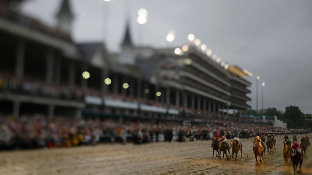 In this photo made with a tilt shift lens, Luis Saez rides Maximum Security across the finish line first during the 145th running of the Kentucky Derby horse race at Churchill Downs Saturday, May 4, 2019, in Louisville, Ky. Country House was declared