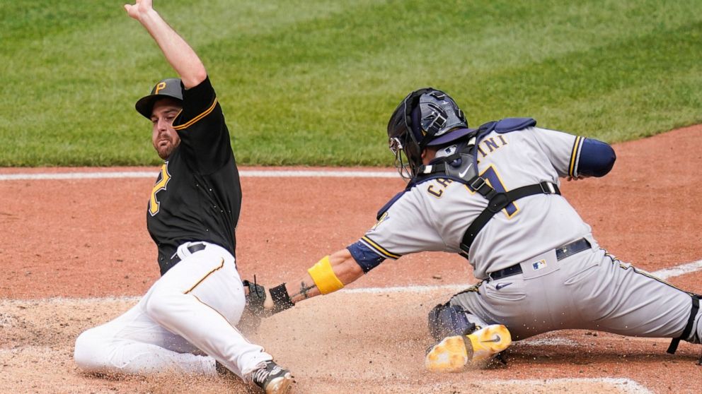 Pittsburgh Pirates' Greg Allen, left, scores past the tag of Milwaukee Brewers catcher Victor Caratini (7) on a hit by Ben Gamel in the seventh inning the a baseball game, Thursday, Aug. 4, 2022, Pittsburgh. (AP Photo/Keith Srakocic)