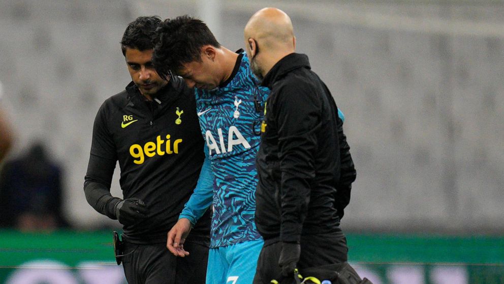 Tottenham's Son Heung-min leaves the field injured during the Champions League Group D soccer match between Marseille and Tottenham Hotspur at the Stade Velodrome in Marseille, France, Tuesday, Nov. 1, 2022. (AP Photo/Daniel Cole)
