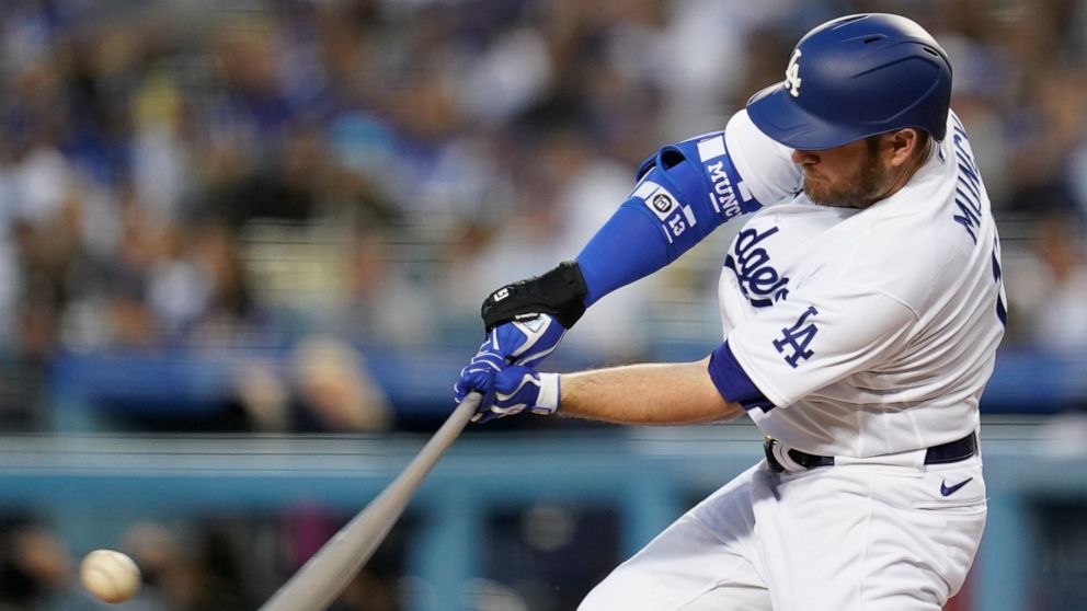 Los Angeles Dodgers' Max Muncy (13) singles during the first inning of a baseball game against the Cincinnati Reds in Los Angeles, Thursday, April 14, 2022. Trea Turner scored. (AP Photo/Ashley Landis)