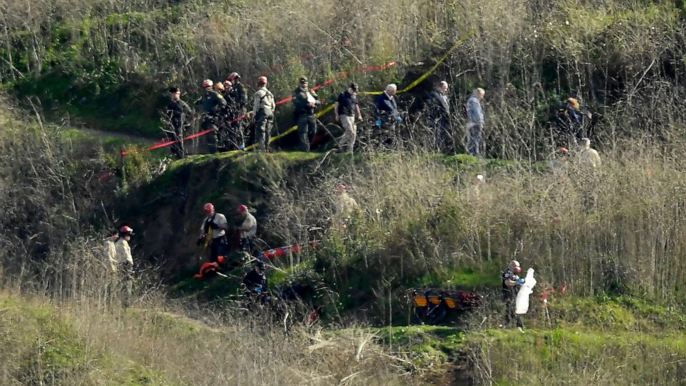 FILE - Investigators work the scene of a helicopter crash that killed former NBA basketball player Kobe Bryant and his teenage daughter, and seven others in Calabasas, Calif., on Jan. 27, 2020. Lawyers for Los Angeles County failed to persuade a fede