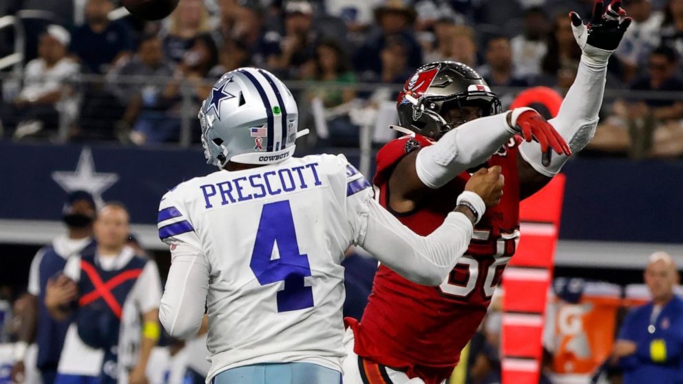 Dallas Cowboys quarterback Dak Prescott (4) is hit by Tampa Bay Buccaneers linebacker Shaquil Barrett (58) while throwing a pass in the second half of a NFL football game in Arlington, Texas, Sunday, Sept. 11, 2022. (AP Photo/Michael Ainsworth)