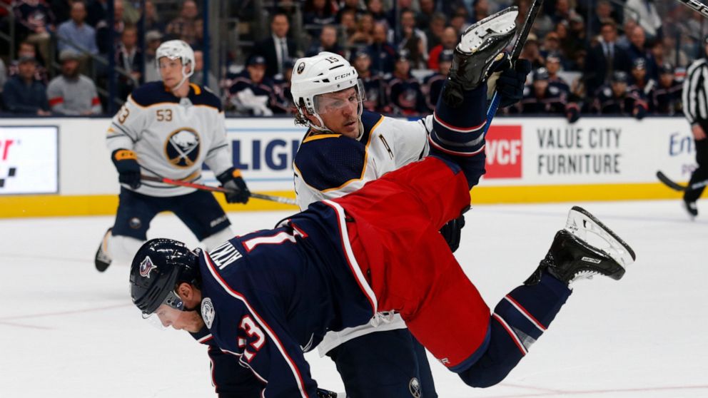 Buffalo Sabres defenseman Jake McCabe, top, upends Columbus Blue Jackets forward Cam Atkinson during the second period of an NHL hockey game in Columbus, Ohio, Monday, Oct. 7, 2019. (AP Photo/Paul Vernon)