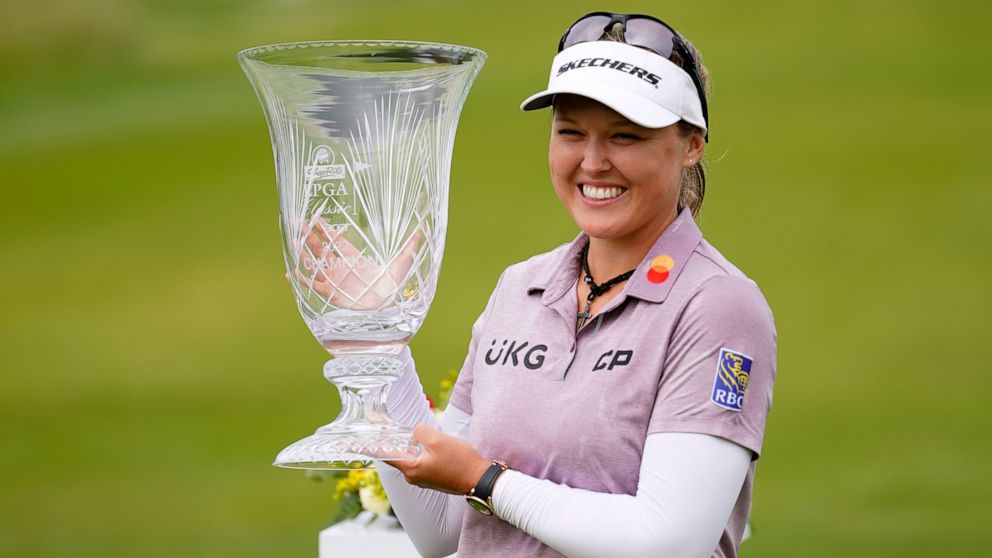 Brooke M. Henderson, of Canada, holds the trophy after winning the ShopRite LPGA Classic golf tournament, Sunday, June 12, 2022, in Galloway, N.J. (AP Photo/Matt Rourke)