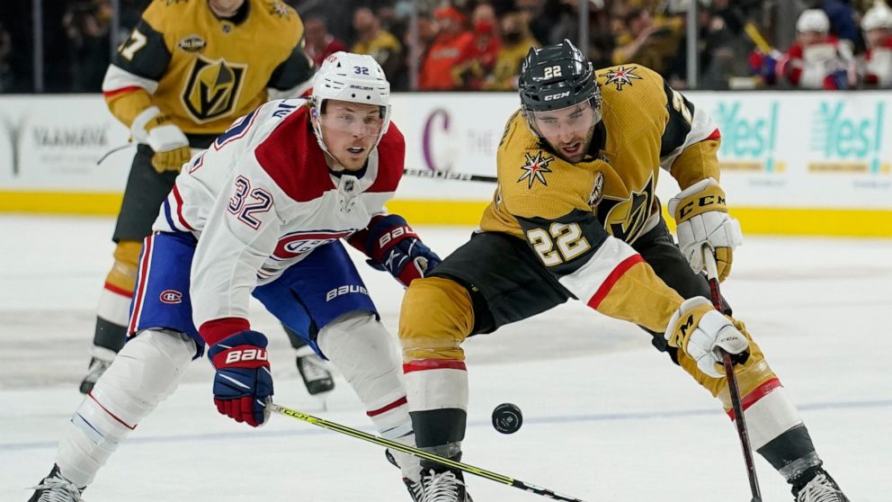 Montreal Canadiens center Rem Pitlick (32) battles for the puck with Vegas Golden Knights center Michael Amadio (22) during the second period of an NHL hockey game Thursday, Jan. 20, 2022, in Las Vegas. (AP Photo/John Locher)