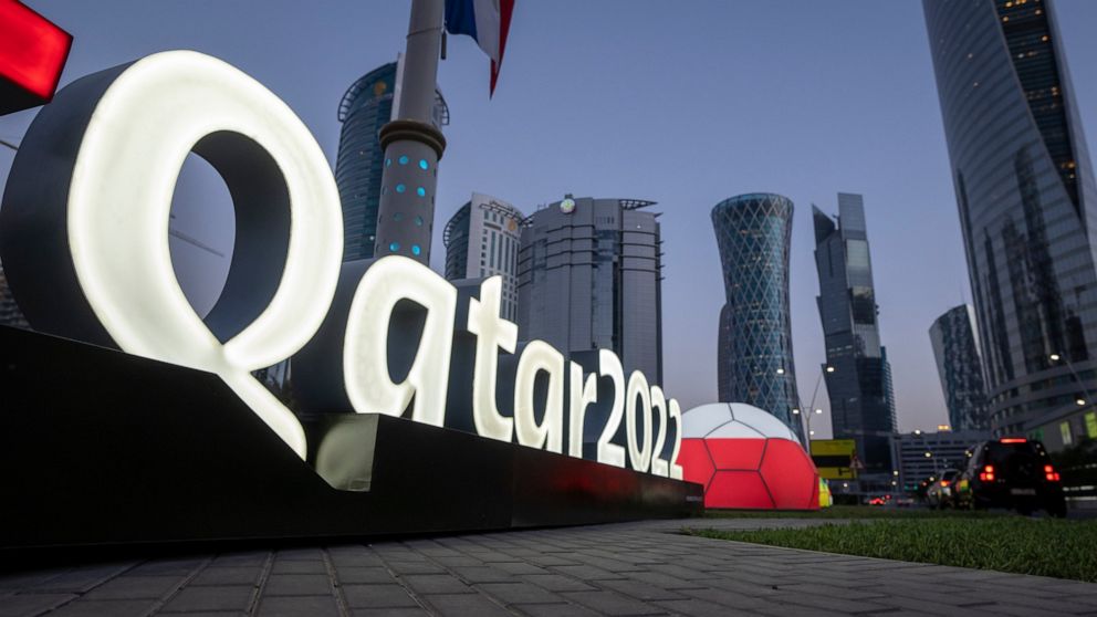 FILE - Branding is displayed near the Doha Exhibition and Convention Center where soccer World Cup draw will be held, in Doha, Qatar, on March 31, 2022. The final draw will be held on April 1. This season will be unique in the 135-year history of dom