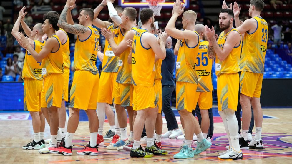 Ukraine's players celebrate at the end of the Eurobasket group C basketball match between Ukraine and Britain at the Assago Forum, near Milan, Italy Friday Sept. 2, 2022. Ukraine beat Britain 90-61.(AP Photo/Luca Bruno)