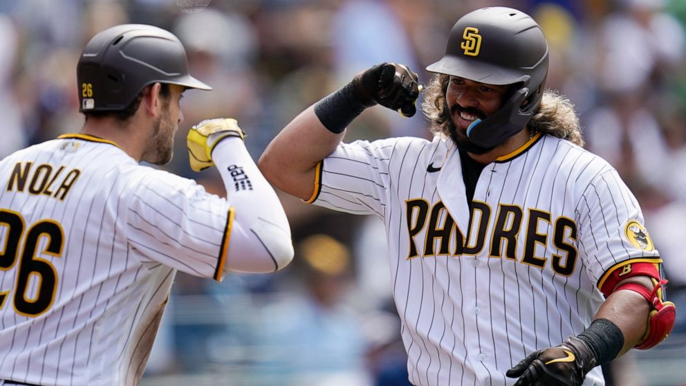 San Diego Padres' Jorge Alfaro, right, is greeted by Austin Nola after hitting a home run against the Arizona Diamonbacks during the sixth inning of a baseball game Wednesday, June 22, 2022, in San Diego. (AP Photo/Gregory Bull)