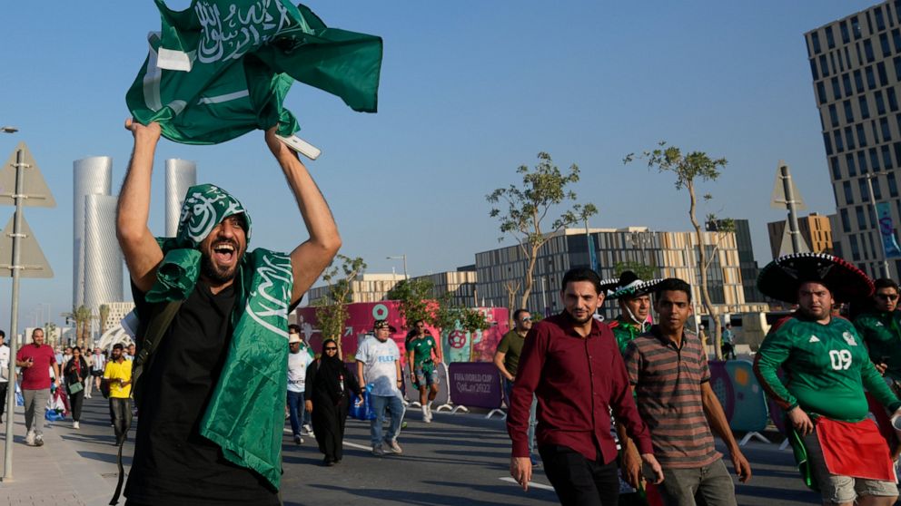 A fan of Saudi Arabia celebrates his team 2-1 victory over Argentina in a World Cup group C soccer match, outside the Lusail Stadium in Lusail Qatar, Tuesday, Nov. 22, 2022. (AP Photo/Andre Penner)