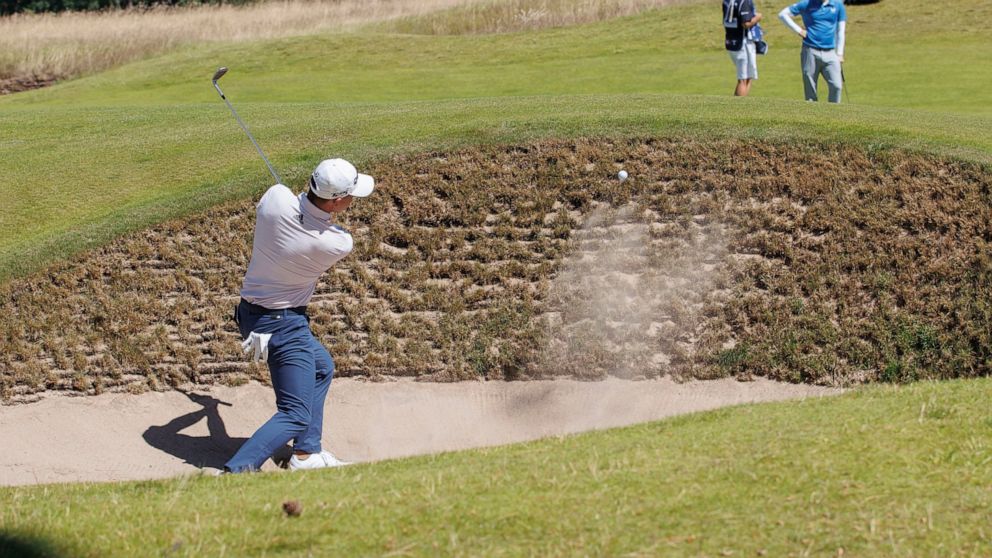 Colin Morikawa from the US plays out of the bunker on the 1st hole during day one of the Scottish Open at The Renaissance Club, North Berwick, Scotland, Thursday July 7, 2022. (Steve Welsh/PA via AP)